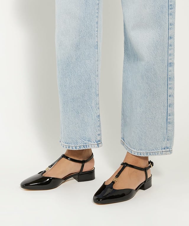 Our high shine patent Heya slingbacks feature an almond toe silhouette. The t-bar features our signature double D logo in gold hardware that matches the buckle on the adjustable ankle strap. Set on low block heel for ease of wear this chic and contemporary style is the perfect choice for day to evening wear.