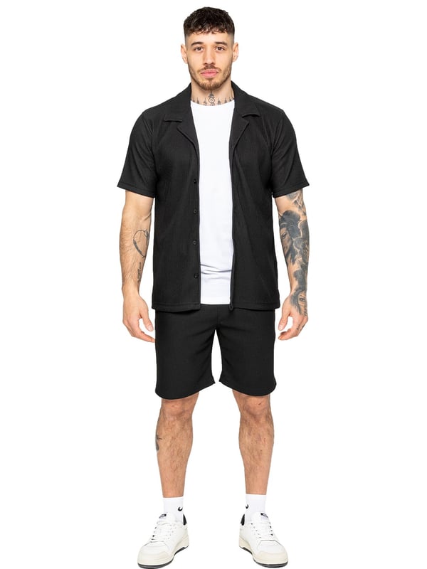 Elevate your summer style with our Enzo Milano Men's Outfit Set, including a textured ribbed revere shirt and relaxed fit shorts. Experience ultimate comfort with a button fastening and adjustable drawstring waistband, while looking effortlessly stylish with a revere collar and single back welt pocket. Made with premium fabric, this set is perfect for any occasion.