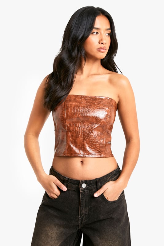 Petite Croc Look Faux Leather Bandeau Corset Top Gain some serious style points this season in this petite top. Cut shorter to ensure the perfect fit, our tops for petite women are designed for queens 5'3'' and below. From petite t-shirts to petite blouses, we've got all the new-season styles you need in your wardrobe. Feeling casual? Dress it down with a pair of straight leg jeans and chunky trainers. If out out is more your vibe, team with some distressed hem shorts and killer heels for a major style statement. Style: CorsetFabric: PUNeckline: Bandeau