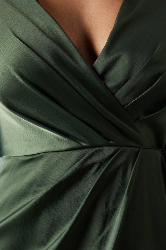 Elegant wrap neckline for a flattering silhouette
        Long sleeves with subtle flare for graceful movement
        Luxurious satin fabric that drapes beautifully
        Waterfall detail adds a touch of romance
        Floor-length design perfect for formal occasions
    
    This stunning Debut London by Coast bridesmaids dress radiates sophistication and grace. The wrap neckline creates a flattering V-shape, while the long sleeves with a subtle flare add an element of elegance. The satin fabric drapes exquisitely, creating a smooth and polished look that's perfect for wedding celebrations. The waterfall detail adds a romantic touch, ensuring you'll stand out in all the right ways. Pair with delicate drop earrings and a sleek updo to complete your bridal party ensemble. This dress is designed to complement the bride while allowing you to shine in your supporting role. Its versatile style ensures you'll feel confident and beautiful throughout the entire wedding day, from the ceremony to the last dance.
