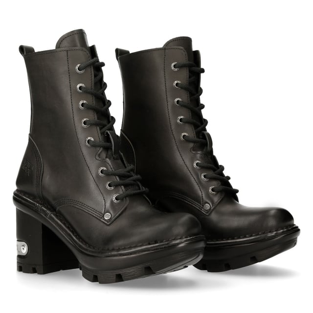 New Rock has paired the classic ankle boot with a high heel that results in a unique and trendy take on the military and biker style shoe. The upper on this shoe is crafted from genuine cow hide and features an 8-eyelet lace fastening and intricately stitched leather panelling to create a smooth and slick finish. The heel measures at 9cm and imbues a bold character onto this boot and features a metallic New Rock logo which has been implemented to stand out against the black design of the shoe. • Heel Height - 9cm• Platform Height - 3cm• Shaft Height - 15cm• Calf Width- 25cm• Outer Material - Cow Hide Leather