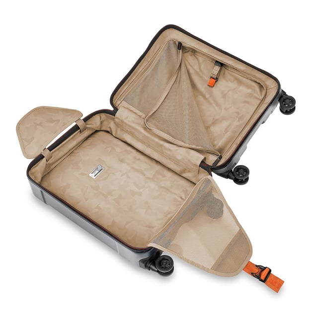 Stop fumbling with zippers and cords and switch to our Torq Domestic Carry-On Spinner. With a USB port and patented hinged front pocket, this bag will be your go-to for all destinations. Lightweight and resilient, take it with you to the city or the beach -- wherever you roam. Key features include: Outsider® handle provides greater interior capacity and a smooth surface for packing so clothes arrive wrinkle-free. Monogrammable leather nameplate to customise with your initials; easily removable and replaceable. External USB port on side of bag connects to a separate battery stored in front pocket, conveniently letting you charge your phone or other device from outside the bag. Integrated padded laptop sleeve in front compartment protects most 15" laptops. Padded tablet slip pocket in front compartment protects most 10.5" tablets.