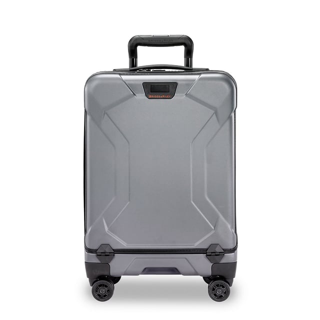 Stop fumbling with zippers and cords and switch to our Torq Domestic Carry-On Spinner. With a USB port and patented hinged front pocket, this bag will be your go-to for all destinations. Lightweight and resilient, take it with you to the city or the beach -- wherever you roam. Key features include: Outsider® handle provides greater interior capacity and a smooth surface for packing so clothes arrive wrinkle-free. Monogrammable leather nameplate to customise with your initials; easily removable and replaceable. External USB port on side of bag connects to a separate battery stored in front pocket, conveniently letting you charge your phone or other device from outside the bag. Integrated padded laptop sleeve in front compartment protects most 15" laptops. Padded tablet slip pocket in front compartment protects most 10.5" tablets.