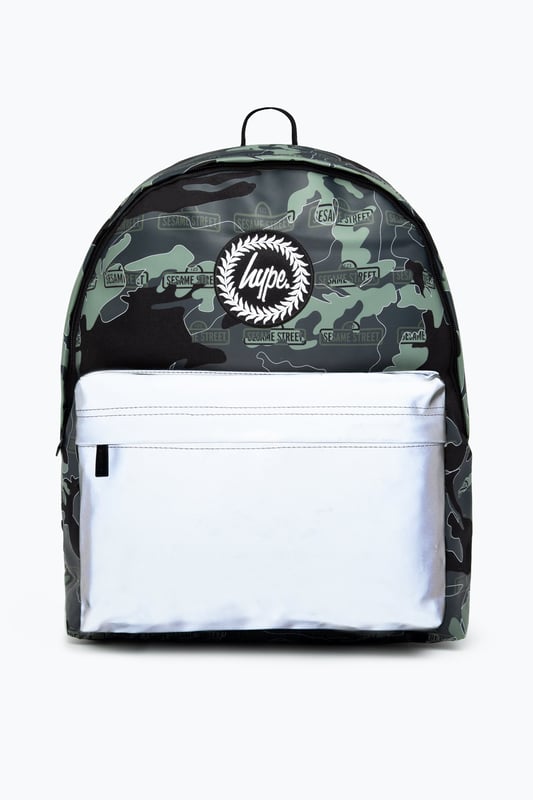 The Hype x Sesame Street Grey Logo Camo Backpack features our signature camo in charcoal, grey and black with the Sesame Street logo on repeat. The front pocket features a reflective fabric for a contrasting look. With a front pocket, puller handle and straps measuring at 42 cms x 30 cms x 12cms, this is the perfect size to transport your essentials. The straps contain the comfort you require with just the right amount of padding. Finished with the iconic HYPE. crest badge in monochrome. Wipe clean only.