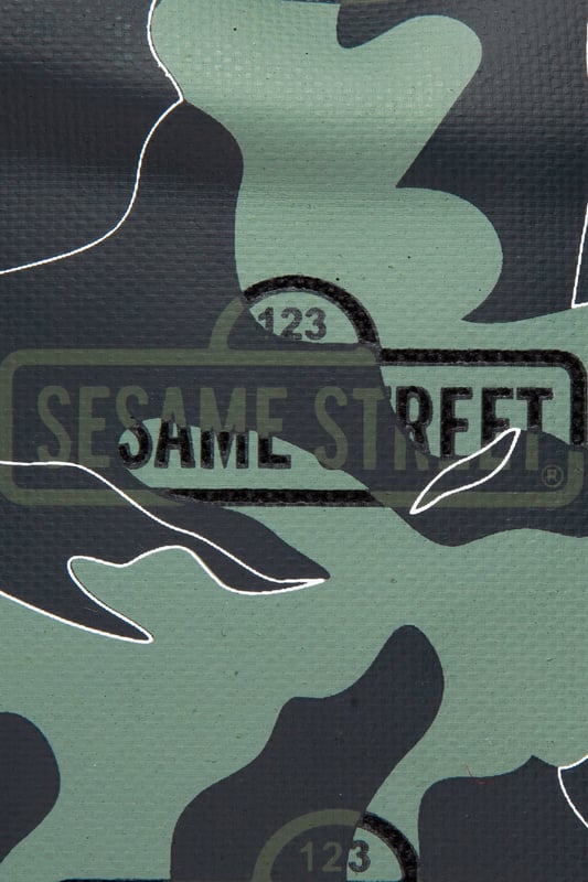 The Hype x Sesame Street Grey Logo Camo Backpack features our signature camo in charcoal, grey and black with the Sesame Street logo on repeat. The front pocket features a reflective fabric for a contrasting look. With a front pocket, puller handle and straps measuring at 42 cms x 30 cms x 12cms, this is the perfect size to transport your essentials. The straps contain the comfort you require with just the right amount of padding. Finished with the iconic HYPE. crest badge in monochrome. Wipe clean only.