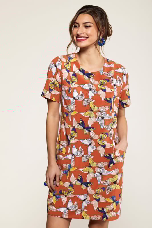 Add something bright to your transitional wardrobe with this Butterfly Tunic Dress With Pocket Detail. Adorned with earthy shades of rust and orange, it's been crafted in a relaxed and easy to throw-on shape with a zip on the back. The short sleeves make it versatile, whilst the practical pockets on the front are ideal for storing your essentials. We're wearing ours with a warm coat and chunky trainers.95% Polyester 5% Elastane. Machine Wash At 30. Length is 90cm/35inches &nbsp;