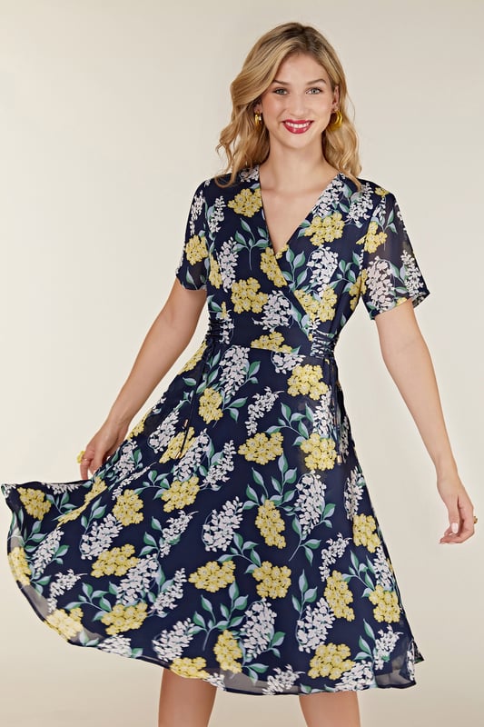 Find your new floral with this must-have Spring Floral Dress With Tie Detail. In the faux-wrap shape that cinches at the waist, it's enhanced by a drawstring that's super-swish and flattering. Our designers have kept the V-neckline elegantly modest, whilst making sure the print is both bright and feminine. Dress it up with wedges and down with trainers. Shell:100% Polyester, Lining:97% Polyester 3% Elastane. Machine Wash At 30. Length 106cm. Model Wears Size 10.