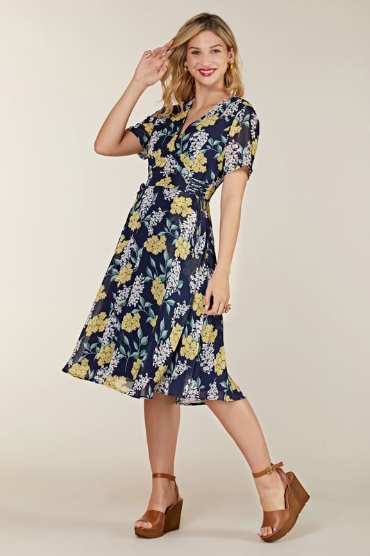 Find your new floral with this must-have Spring Floral Dress With Tie Detail. In the faux-wrap shape that cinches at the waist, it's enhanced by a drawstring that's super-swish and flattering. Our designers have kept the V-neckline elegantly modest, whilst making sure the print is both bright and feminine. Dress it up with wedges and down with trainers. Shell:100% Polyester, Lining:97% Polyester 3% Elastane. Machine Wash At 30. Length 106cm. Model Wears Size 10.
