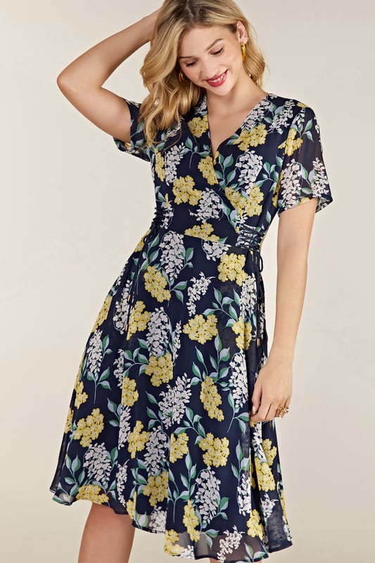 Find your new floral with this must-have Spring Floral Dress With Tie Detail. In the faux-wrap shape that cinches at the waist, it's enhanced by a drawstring that's super-swish and flattering. Our designers have kept the V-neckline elegantly modest, whilst making sure the print is both bright and feminine. Dress it up with wedges and down with trainers. Shell:100% Polyester, Lining:97% Polyester 3% Elastane. Machine Wash At 30. Length 106cm. Model Wears Size 10.