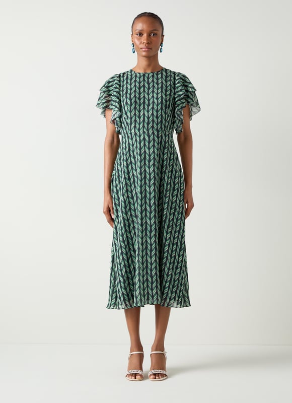 Embrace elegance with the Agnes ribbon print georgette frill dress. This beautifully crafted piece is adorned with picot edging, a convenient zip closure, a scoop neck, and full length sleeves. Perfect for evening occasions, complement it with heels and a clutch or ballet flats for a sophisticated, relaxed look.