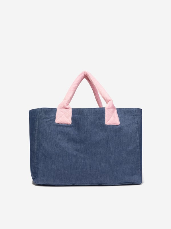Carry life's essentials in style with this blue tote bag from AY by Ayla. The denim style piece exhibits a chic demeanour, elevating any look. Pink fleece handles are soft on skin and create a cute contrast. Pair with any other AY blue or pink garments for a cool coordinated look.