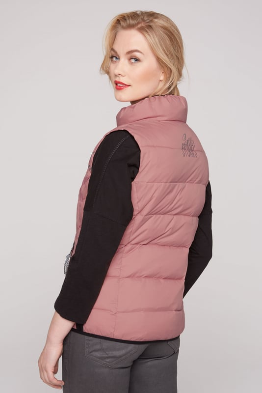 Een decoratieve logoprint siert de voorkant van het gewatteerde vest van SOCCX voor dames. Ook staat er een kleine print op de bovenrug. Het vest voelt heerlijk licht aan, heeft contrasterende strepen aan de zijkanten en een elastische boord. Ook is het voorzien van praktische zakken met rits. Zeer aangenaam om te dragen, comfortabel en sportief gesneden tegelijk. Kan met veel kledingstukken worden gecombineerd.