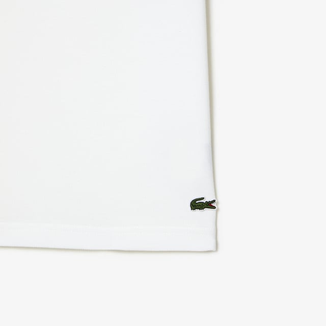 Proud of Lacoste’s DNA  revisiting our iconics in a contemporary way Regular fit  natural ease on body Iconic petit pique Graphic polo 2 rubber buttons placket 3cm green crocodile at bottom garment - left side when worn Lacoste stripe gradient and crocodile print at chest