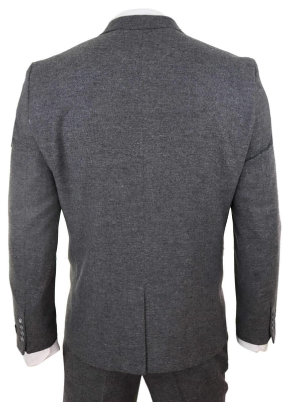 A grey suit is a key staple in every mans wardrobe and this one is no exception to this unwritten rule. Sharp, sleek and sophisticated, look the part with this premium 3 piece grey wool tweed suit, that features a slim fit cut, with a closer fit across the chest and narrower tailored trousers. the two-button jacket hangs beautifully and has a half canvas construction that moulds to your body shape the more you wear it. Contrasting velvet pocket piping, buttoned cuffs and a single back vent lend the suit a classic touch of refinement. A matching tweed waistcoat completes the 3-piece with a single breasted down style with classic tailored pockets and a back adjuster to ensure you can create your ideal fit. The suit is evergreen and contemporary at the same time and allowing you to look the best all day. Pair it with a matching waistcoat, a white shirt and shoes for a dapper finish.