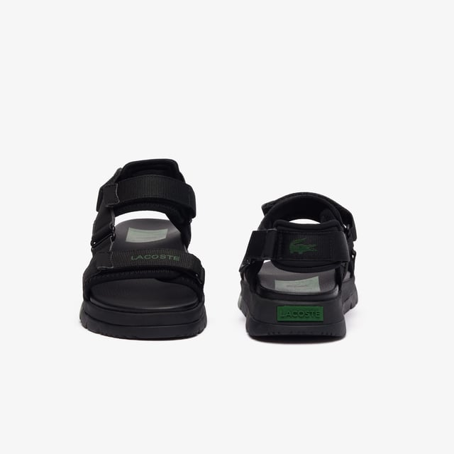 • Padded neoprene cushioning under straps • Synthetic leather footbed • Rubberised print Lacoste wording to front strap • Crocodile heel branding to rear strap • Lightweight rubber outsole with colour-blocked sections.