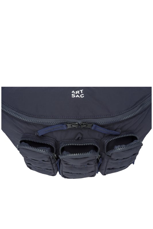 The perfect practial edition to any outfit. This unique triple-pocket design sling bag has enough internal and external space to carry all your every day essentials. Features: , Padded lightweight nylon, Water resistant, Zip top opening to main compartment, ARTSAC screen printed logo, Triple front zip pocket with loops, Internal zip pocket, External rear zip pocket, Top grab handle, 2 Mobile phone internal net pockets, Adjustable shoulder strap allowing backpack styling or bum bag styling Style Ref: 52014 NAVY
