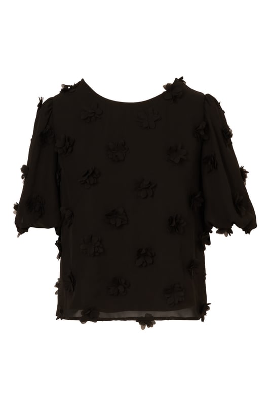 Add a fun dimensional moment to your outfit with this cute short sleeve top dotted with fluttery chiffon flower appliques. Balloon sleeves hit just above the elbow to complete the sweet, romantic feel of this blouse. A keyhole button closure at the back finishes the crew neck collar. Perfect for work and weekend style, you will love the way this charming top dresses up any look.