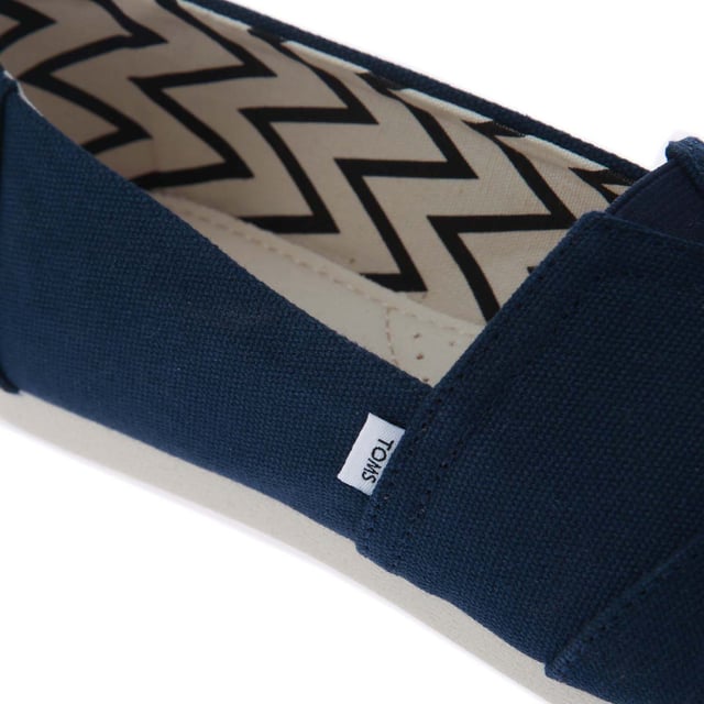 Womens Toms Recycled Cotton Canvas Alpargata Espadrille Pumps in navy.- Recycled cotton upper  lining and sock-liner made with 50% recycled cotton.- Classic Alpargata design.- Toe-stitch and elastic V for easy on and off.- Chevron patterned canvas lining.- Custom insoles made with 50% eco content including recycled PU foam.- Direct injection outsole for flexibility and durability with tread pattern for improved traction.- Toms branding to side and back of heel.- 100% vegan construction.- Textile upper  Textile lining  Synthetic and textile sole.- Ref:10017712