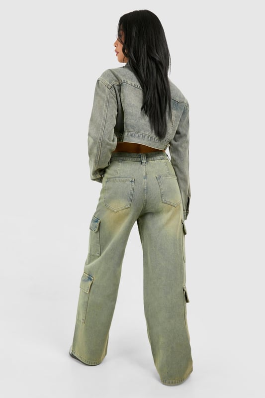 Wide leg cargo jeans with vintage wash effect
        Multiple utility pockets for added functionality
        Cropped jacket with matching wash and pocket details
        High-waisted design for a flattering silhouette
        Relaxed fit through legs for comfort and style
    
    Make a bold statement with these eye-catching cargo jeans, perfect for the fashion-forward trendsetter. The wide-leg silhouette offers a contemporary twist on a classic denim style, whilst the vintage wash adds character and depth. Pair with the coordinating cropped jacket for a head-turning denim-on-denim ensemble that's sure to turn heads. For a casual daytime look, team with a simple white crop top and trainers. Dress it up for evening drinks by swapping trainers for heeled boots and adding statement jewellery. These versatile jeans are ideal for various casual occasions, from weekend brunches to music festivals. The multiple pockets not only add to the utilitarian aesthetic but also provide practical storage for your essentials. Embrace the Y2K revival trend and make these cargo jeans your go-to piece for effortless, street-style inspired outfits.