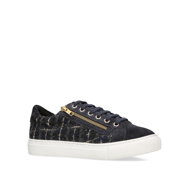 The Dulwich Zip sneaker features a navy tweed fabric upper with flecks of gold running through. The front laces up with gold eyelets to the side of a gold zip.