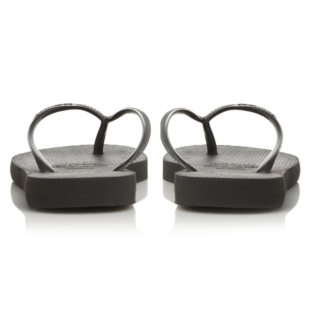 Embrace the summer in this casual flip flop by Havaianas. Slim fit design with white sole and toe post. Sizing is an adjusted fit meaning the foot fits to the edge of the sole.