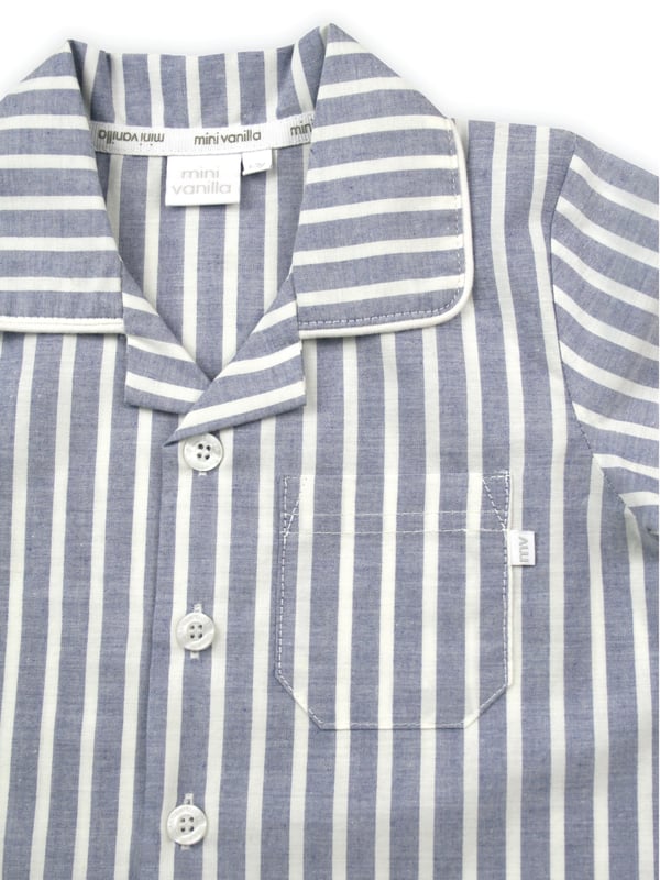 Blue and White Stripe Traditional Summer Pyjamas.

Our classic short sleeve crisp summer cotton boys pyjamas in a blue and white stripe creates a traditional look that’s perfect for lounging or sleeping. Made from super-soft 100% crisp cotton. The set is trimmed with white cotton piping. The top has an open collar and revere, single square pocket with MV tab and fastens with Mini Vanilla Engraved buttons. The crisp cotton comfy trousers have a fully soft elasticated waist and white piping at the hem to finish this very traditional boys pyjamas

Sold as a Pyjama set.
Fabric 100% cotton - crisp summer weight.
Fire Warning : KEEP AWAY FROM FIRE AND FLAMES.
Wash Care Instructions : Machine wash inside out, do not soak, wash dark                    colours separately, do not iron trims. Save energy and wash at 30 degrees.
Do not tumble dry
