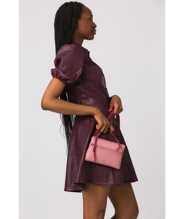 The 'Sweetie' cross body bag from Conkca London is handcrafted from multi-toned leather for a beautiful finish. A zip-over top opens to reveal a spacious yet compact main compartment with two slip pockets, lined with natural and untreated 100% cotton. Features a zipped pocket on the front and a slip pouch on the rear, ideal for on-the-go storage. Comes with an adjustable leather strap with a maximum drop length of 70cm. Adorned with the inimitable Conkca squirrel charm and Conkca logos.