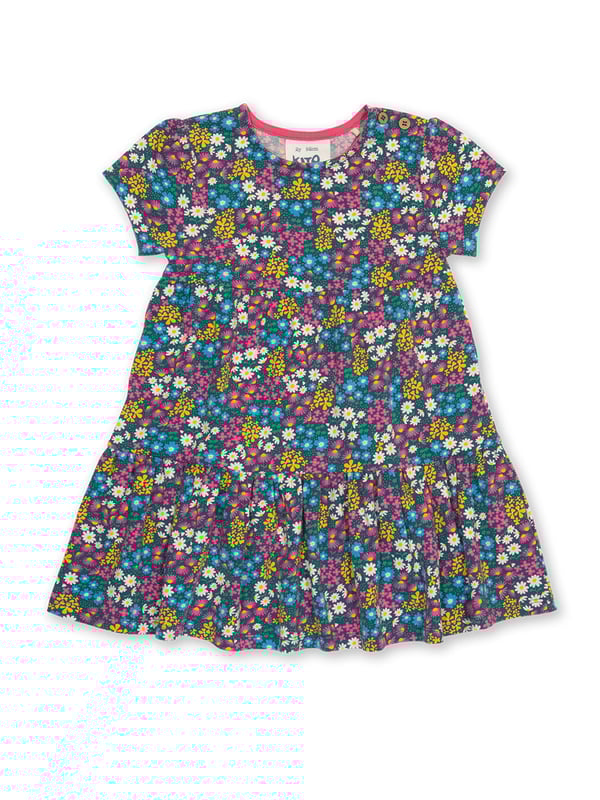 95% organic cotton 5% elastane | Proud to be certified to the Global Organic Textile Standard (GOTS) | Flower patch all-over print | Single jersey with a little bit of stretch (180-190 gsm) | Tiered style | Coconut button shoulder opening (up to and including size 3 years) | Short sleeved | Round neck | Made in Turkey | Machine washable at 40 degrees, or at 30 degrees to be kinder to the planet