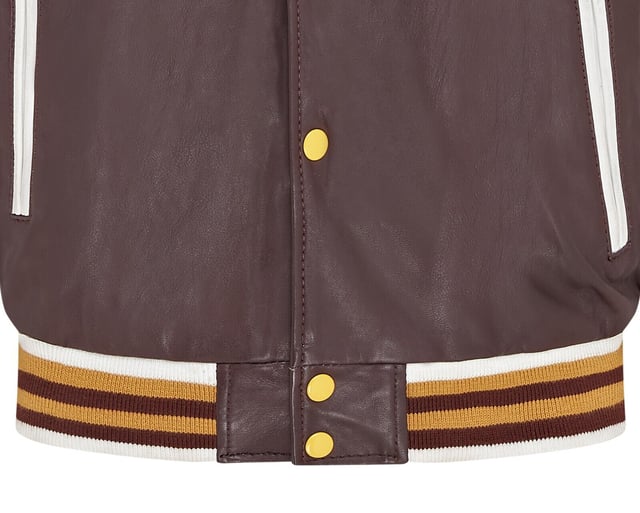 Introducing the Men's Baseball Leather Jacket, a perfect blend of classic varsity style and modern craftsmanship. This letterman bomber jacket features contrasting sleeves and a striped knit ribbed collar, waistband, and cuffs for a timeless athletic look. The press studs front closure and embroidered brand logo patches on the chest and sleeves add a touch of authenticity and flair. Designed with practicality in mind, it includes two jet pockets at the waist and two inside welt pockets for your essentials. The panelling to the back of the jacket ensures a tailored fit and superior comfort.

Contrasting sleeves for a stylish look
Striped knit ribbed collar, waistband, and cuffs for a classic finish
Press studs front closure for easy wear
Embroidered brand logo patches on the chest and sleeves for added detail
Two jet pockets at the waist and two inside welt pockets for convenience