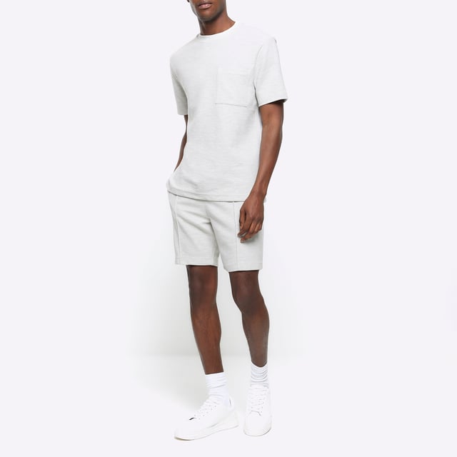 Regular fit, Textured fabric, Chest pocket, Crew neckline, Short sleeves, Cotton for this product has been more responsibly sourced