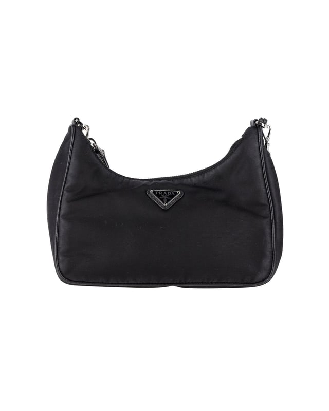 VINTAGE, RRP AS NEW
Elevate your bag collection with the Prada Re-Edition 2005 Re-Nylon Mini Bag. Featuring a timeless mini hobo design, this bag is an iconic piece from Prada. Crafted from Re-Nylon, a material created from recycled plastic trash, it not only makes a stylish statement but also supports sustainable practices. The bag is enhanced with iconic Saffiano leather trims. With a zipper closure for security, an enameled metal triangle logo for a chic brand detail, and a removable chain strap for versatility, this Prada mini bag checks all the boxes of style, functionality, and eco-consciousness.
Prada Re-Edition 2005 Re-Nylon Mini Bag in Black Nylon
Condition: Excellent
Sign of wear: No
Material: Nylon
Color: Black
Dimensions:  
Length: 250 mm
Width: 130 mm
Height: 150 mm
SKU: 358544 / NAPBKGBBA303249W  
Size: One Size