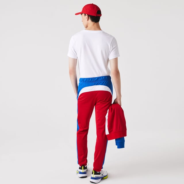 Men's Lacoste SPORT Run-Resistant Tennis Trackpants.- Regular fit, natural ease: The perfect fit for workouts.- Drawstring waist: Customised comfort and fit.- Contrast print on side: The iconic Lacoste colour-block.- Rigid crocodile sewn onto front: Quintessentially Lacoste.- Recycled polyester run-resistant piqué: Lightweight. Environmentally friendly. Material: 100% Polyester. Ref: XH9427W50.