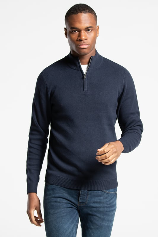 This 1/4 zip jumper from Kensington Eastside is a wardrobe essential. This jumper features ribbed elasticated details on the 1/4 zip funnel neck, cuffs, and hem. This jumper is made from cotton blend fabric, ensuring comfortability and warmth.