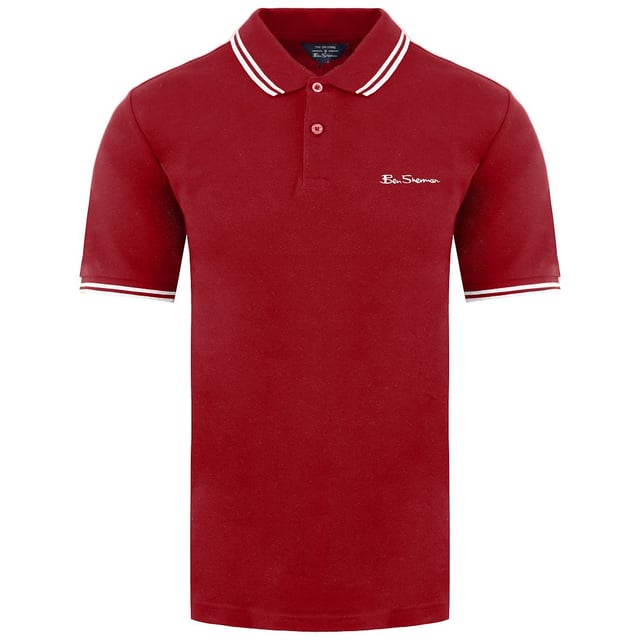 Ben Sherman Twin Tipped Men's Red Polo Shirt, a classic and iconic garment that embodies the timeless style and sophistication that the brand is known for. Elevate your wardrobe with this vibrant and stylish polo shirt, perfect for adding a pop of color to your casual or semi-formal outfits.

Key Features:

 Premium Quality Material:  The Ben Sherman Red Polo Shirt is crafted from high-quality cotton fabric, offering exceptional comfort, breathability, and a soft touch against the skin. Experience the luxury of superior craftsmanship with every wear.

 Iconic Twin-Tipped Design:  The signature twin-tipped detailing on the collar and cuffs is a hallmark of Ben Sherman's renowned style. The subtle contrast trim adds a touch of elegance, setting this polo shirt apart from the rest.

 Vibrant Red Shade:  The striking red color exudes confidence and energy, making a bold statement wherever you go. This attention-grabbing hue is sure to garner compliments and turn heads.

 Flattering Fit:  Designed to complement various body types, the Ben Sherman Polo Shirt features a tailored silhouette that enhances your physique without compromising on comfort.

 Versatile Wardrobe Staple:  This red polo shirt effortlessly transitions between casual and semi-formal settings. Whether you pair it with jeans, chinos, or shorts, it creates a stylish look for a range of occasions.

 Embroidered Brand Logo:  The discreetly embroidered Ben Sherman logo on the chest showcases the brand's heritage and commitment to quality, guaranteeing an authentic and genuine product.

 All-Season Wear:  Suitable for year-round wear, this polo shirt adapts to different weather conditions, making it a versatile and practical addition to your clothing collection.