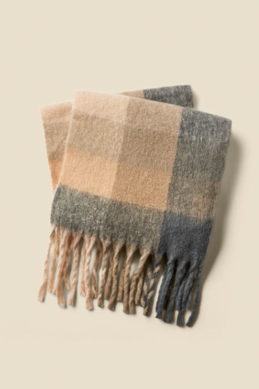Wrap up in style Spun from luxuriously soft fabric for serious warmth Long length for maximum cosiness Checks are always on-trend Neutral tones make it so versatile Throw on with a biker or a chic longline coat