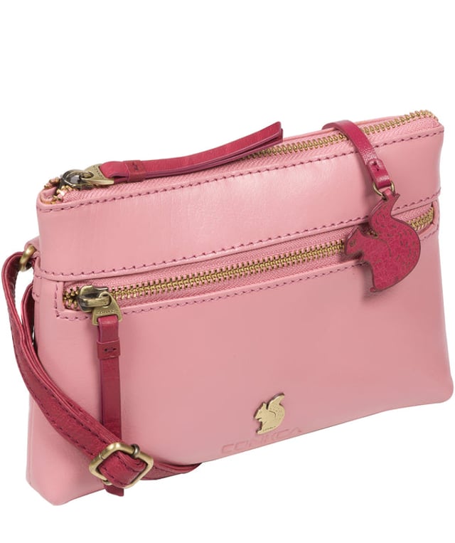 The 'Sweetie' cross body bag from Conkca London is handcrafted from multi-toned leather for a beautiful finish. A zip-over top opens to reveal a spacious yet compact main compartment with two slip pockets, lined with natural and untreated 100% cotton. Features a zipped pocket on the front and a slip pouch on the rear, ideal for on-the-go storage. Comes with an adjustable leather strap with a maximum drop length of 70cm. Adorned with the inimitable Conkca squirrel charm and Conkca logos.