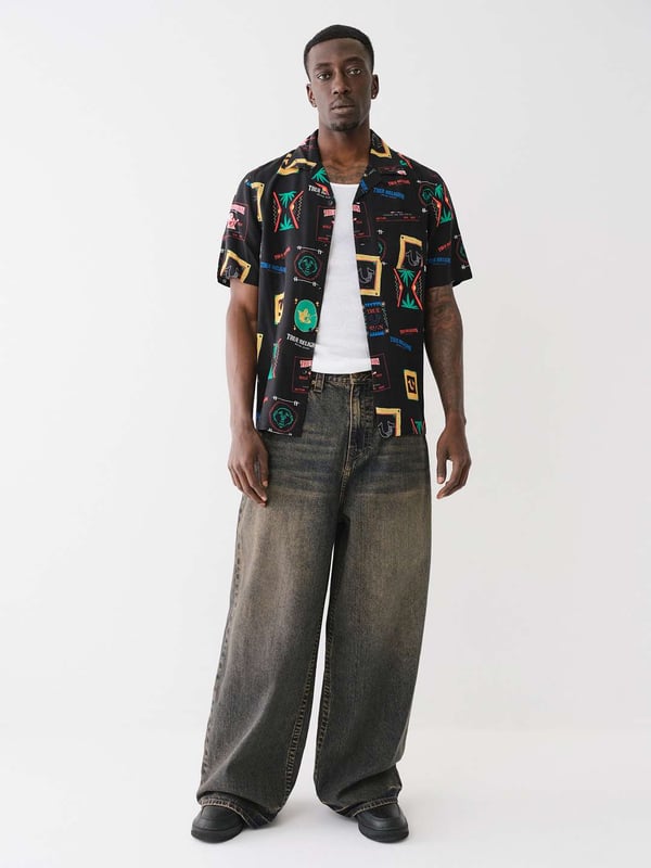 Grab your luggage and head to somewhere tropical in the Resort Print Camp Collar Shirt. Crafted from a soft woven fabrication, this men’s shirt features an allover conversational resort print, camp collar, short sleeves, and button-front closures.