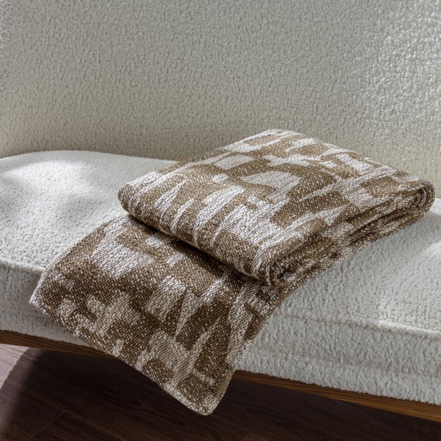 Inspired by modern and minimalist art, the Ola throw features abstract shapes on a soft handled woven jacquard base, in a range of muted earth tones. Ideal for creating a relaxed look in a modern, neutral interior.