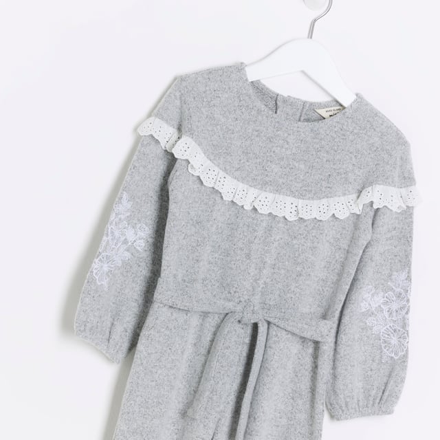 Broderie trim, Embroidered arm detail, Tie waist detail, Button back, Long sleeve, Cuffed hem