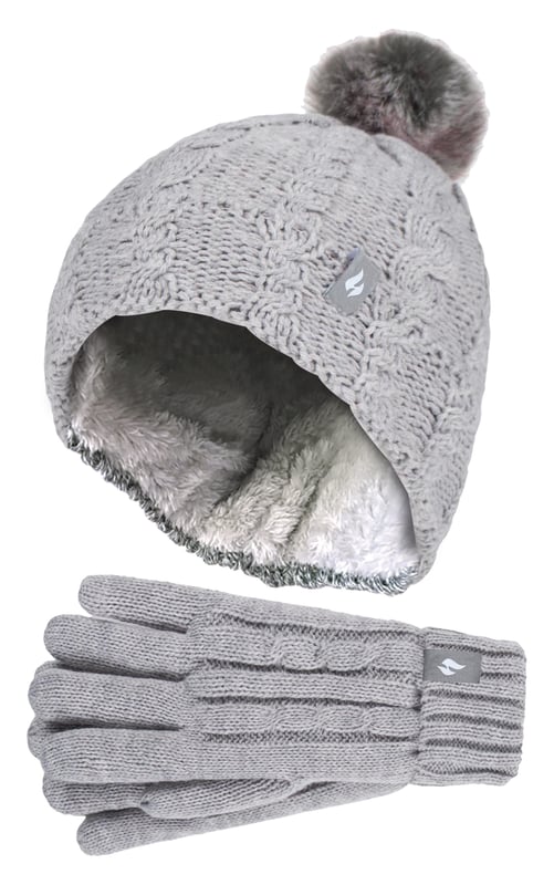 Keep your child warm in this dreary Winter weather with this Faux Fur Pom Pom Hat and gloves for girls. Ideal for snow sports or any outdoor activities, this hat and gloves set will retain heat and warmth close to skin whether your child is throwing snowballs or enjoying a Winter stroll. Designed with specially developed thermal yarn, this set provides high performance insulation against cold with superior moisture breathing abilities. The stretchable construction contours around the natural shape of your body for improved fit, warmth and comfort. Heat Holders products, including this set of hat and gloves, features a HeatWeaver insulation which is a plush fur-like thermal lining that maximises the amount of warm air held close to the skin. The matching hat and gloves features a unique cable knit like design, making this set an essential Winter wardrobe collection! They also have a ribbed turn over cuff on the gloves for a more comfortable fit to the wrist. Additionally, the pull on beanie style features a ribbed turn over cuff for a stylish Winter look. This feature also allows a better and improved fitting to the head. Keep ears warm and toasty in this faux fur pom pom bobble hat! This set of hat and gloves are available in 5 colours of Oatmeal Twist, Navy, Black, Dusty Grey, and Dusky Pink. These hats and gloves are available in 7-10 years.