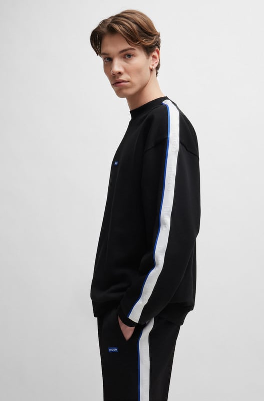 A fresh sweatshirt by HUGO Menswear. Designed in cotton terry  this regular-fit layer is trimmed with a branded patch and tape down the shoulders. mid weight french terry like rectangle logo story - HUGO BLUE logo patch on center chest - HUGO BLUE tape on arm and shoulder - ribbed collar  hem and cuffs