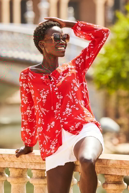 REASONS TO BUY:

Florals to make you feel good
Flattering scoop neck and longline hem
Button front and tie neck detail
Semi-sheer fabric
On-trend blouson sleeves
Wear it with white shorts and wedges