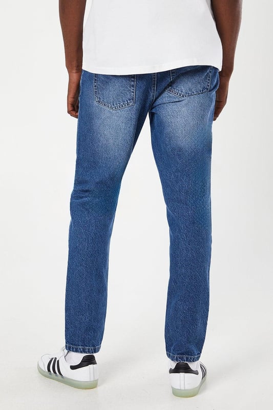Slim fit design for a modern, tailored silhouette
        Classic five-pocket styling for practicality
        Mid-wash denim offers versatile styling options
        Subtle whiskering and fading for a lived-in look
        Belt loops for optional accessorising
    
    These Maine slim fit jeans are a wardrobe essential, perfect for the modern gent who values both style and comfort. The mid-wash denim provides a versatile canvas for countless outfit combinations, suitable for casual outings or relaxed work environments. Pair them with a crisp white tee and trainers for an effortlessly cool weekend look, or dress them up with a button-down shirt and loafers for smart-casual occasions. The slim fit flatters the silhouette without compromising on comfort, making these jeans ideal for long days out and about. Whether you're meeting friends for a pub lunch or attending a family gathering, these jeans will keep you looking sharp and feeling at ease. Their durability and timeless design ensure they'll remain a go-to choice in your wardrobe for seasons to come.