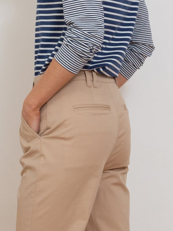 98% organic cotton 2% elastane | Beige | Twill fabric with a little bit of stretch | Apple enzyme washed for a soft hand feel | Zip and coconut button opening | Functional belt loops | Side pockets and back welt pockets | Cropped slim leg | Front pleating detail for a flattering fit | Made in Turkey | Machine washable at 40 degrees, or at 30 degrees to be kinder to the planet