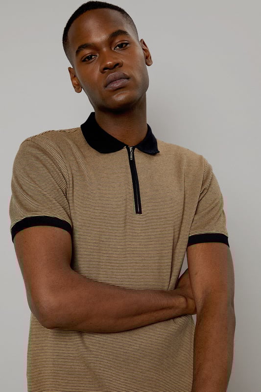 Contrast collar and cuffs for a distinctive look
        Quarter-zip neck design for adjustable style
        Short sleeves perfect for warmer weather
        Versatile woven fabric for comfort and durability
        Classic polo silhouette with a modern twist
    
    This Burton polo shirt combines timeless style with contemporary details, making it a versatile addition to any casual wardrobe. The contrast collar and cuffs add a touch of sophistication, while the quarter-zip neck allows for customisable comfort. Perfect for a range of casual occasions, from weekend outings to laid-back gatherings with mates. Pair it with dark trousers and trainers for a smart-casual look that's ideal for a pub lunch or family barbecue. The woven fabric ensures lasting wear, making this polo a go-to choice for the man who appreciates both style and practicality. Whether you're heading to a casual work event or meeting friends for a game of golf, this polo shirt offers the perfect blend of comfort and classic British style.