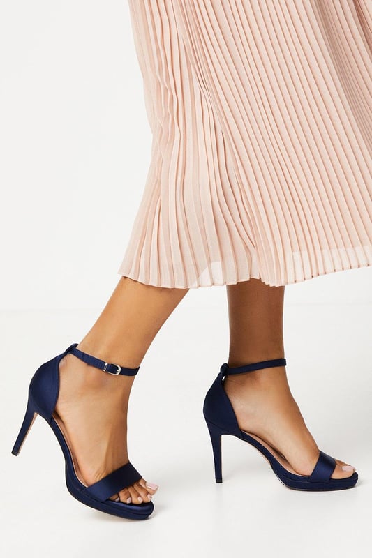 Elegant faux leather heeled sandals with a platform sole
Ankle strap with metallic buckle fastening for a secure fit
Open toe design to elongate the leg
Towering stiletto heel height of 7-9cm
Metallic finish exudes sophistication and glamour

Crafted with meticulous attention to detail, these Talia Platform Heeled Sandals from Coast are the epitome of refined elegance. Designed to make a statement at formal occasions like weddings, races, or graduations, these sandals radiate luxury. Style them with a floor-length gown or a tailored midi dress for a polished and sophisticated look that commands attention. Embrace the allure of these sandals and let them be the centerpiece of your ensemble, elevating your confidence and poise for an unforgettable evening.
