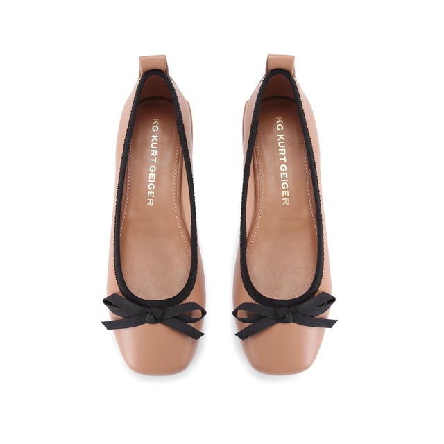The KG Kurt Geiger Marvyn is a camel ballet flat with black bow on the toe and flat block style heel.