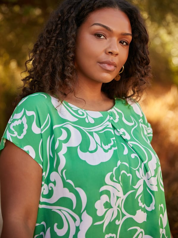 Printed all over with a pretty green paisley print, this top is cut from a lightweight woven fabric thats so comfortable. With a flattering V-neckline with a pleat, it has short sleeves for coverage, making this the perfect throw-on warm weather piece.