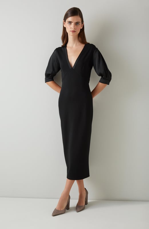 Imagine the perfect blend of sophistication and modern flair. The Daisy crepe dress in timeless black features rib knit trims and dome metal buttons, crafted from luxurious viscose with a stand frill collar and full length sleeves. Pair it effortlessly with ankle boots for a day out or style it with heels for an evening event.