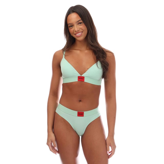 A signature triangle bra featuring a red logo label on the band by HUGO Womenswear. This design is crafted in stretch jersey with removable padding. This product is partly made with organic cotton.